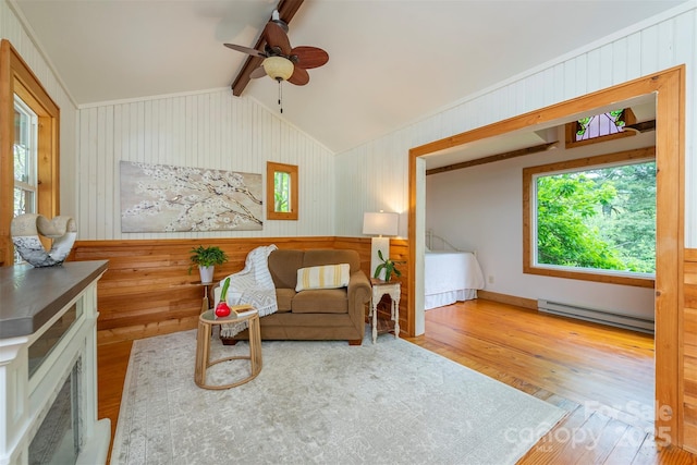 528 Padgettown Rd, Black Mountain, NC 28711 - living area with a baseboard radiator, wood finished floors, a ceiling fan, and wood walls