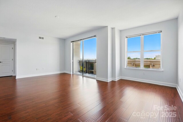 1315 E Blvd Unit 611, Charlotte, NC 28203 - spare room featuring dark wood-style floors and baseboards