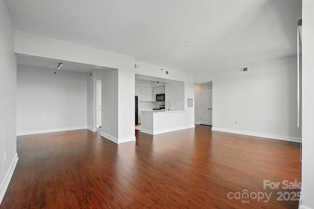 1315 E Blvd Unit 611, Charlotte, NC 28203 - unfurnished living room with dark wood finished floors