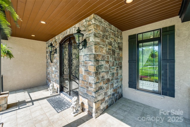 546 Little Cove Ln, Lake Wylie, SC 29710 - property entrance featuring stucco siding, covered porch, and stone siding