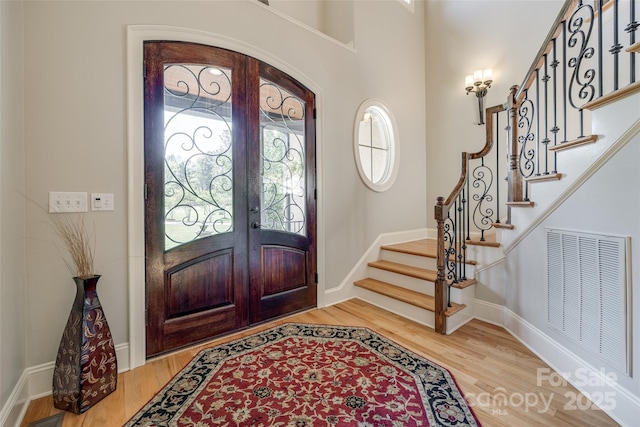 546 Little Cove Ln, Lake Wylie, SC 29710 - entrance foyer featuring light wood finished floors, french doors, stairway, and baseboards