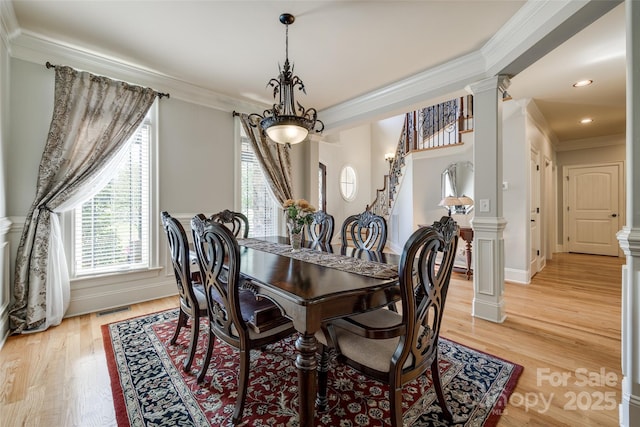 546 Little Cove Ln, Lake Wylie, SC 29710 - dining space with crown molding, decorative columns, light wood-type flooring, and stairs