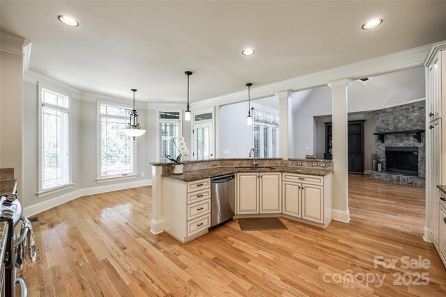 546 Little Cove Ln, Lake Wylie, SC 29710 - kitchen with stainless steel appliances, a sink, light wood-type flooring, a stone fireplace, and crown molding