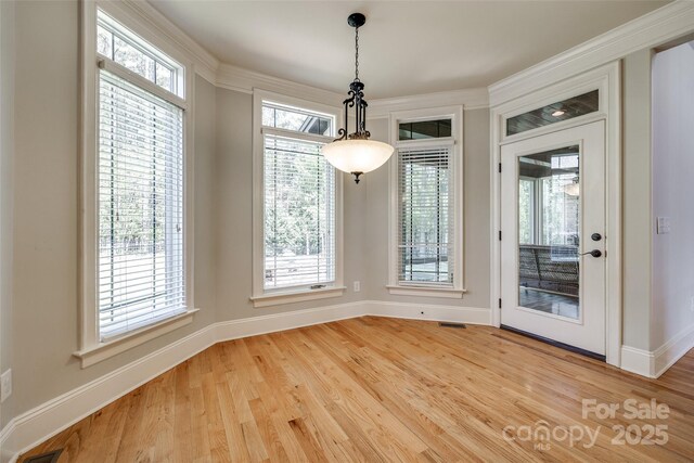 546 Little Cove Ln, Lake Wylie, SC 29710 - unfurnished dining area with light wood-style flooring, baseboards, and ornamental molding