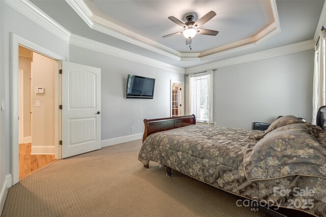 546 Little Cove Ln, Lake Wylie, SC 29710 - carpeted bedroom with a tray ceiling, ornamental molding, ceiling fan, and baseboards