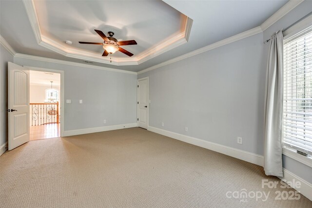546 Little Cove Ln, Lake Wylie, SC 29710 - spare room featuring a raised ceiling, a ceiling fan, crown molding, light carpet, and baseboards