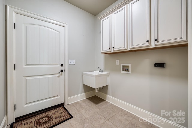 546 Little Cove Ln, Lake Wylie, SC 29710 - laundry room with cabinet space, washer hookup, baseboards, and light tile patterned floors