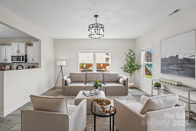 3092 Riker St, Clover, SC 29710 - living area with wood finished floors, baseboards, and a chandelier