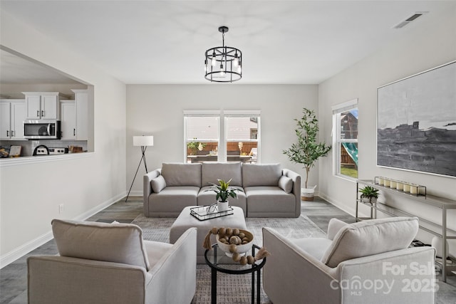 3092 Riker St, Clover, SC 29710 - living room featuring healthy amount of natural light, baseboards, a chandelier, and wood finished floors