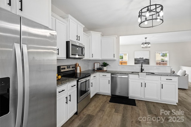 3092 Riker St, Clover, SC 29710 - kitchen featuring appliances with stainless steel finishes, a sink, a chandelier, a peninsula, and dark wood-type flooring