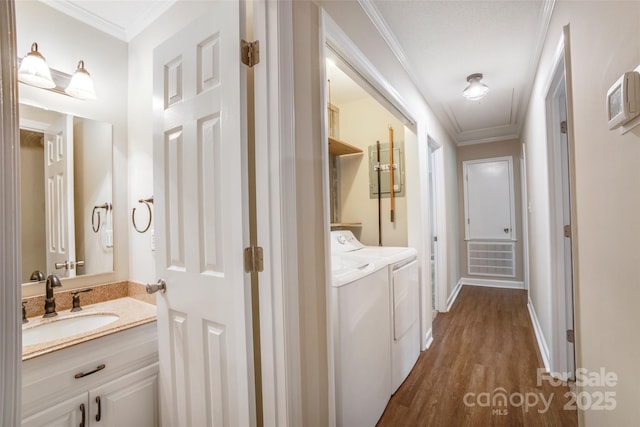 2434 Olewoods Ct, Rock Hill, SC 29732 - washroom with washing machine and dryer, dark wood finished floors, ornamental molding, attic access, and baseboards