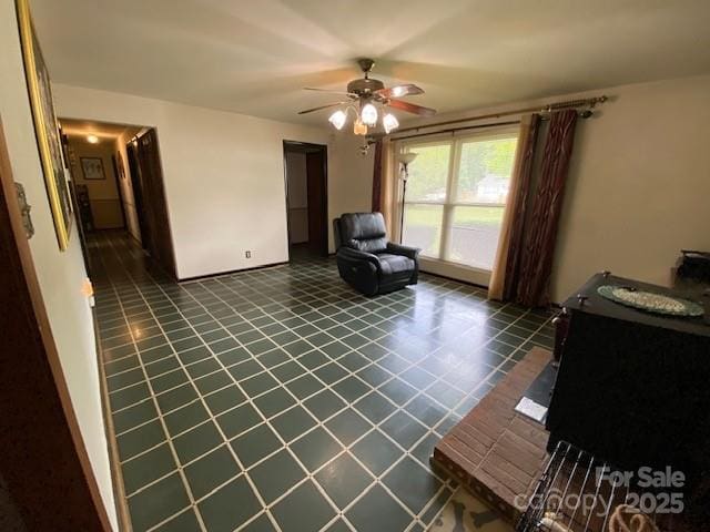 13427 Homewood Dr, Charlotte, NC 28262 - living area featuring dark tile patterned floors and ceiling fan