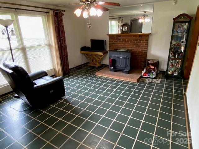 13427 Homewood Dr, Charlotte, NC 28262 - living room with a ceiling fan, tile patterned flooring, and a wood stove