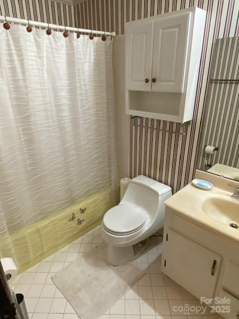 13427 Homewood Dr, Charlotte, NC 28262 - bathroom with wallpapered walls, tile patterned floors, toilet, vanity, and curtained shower