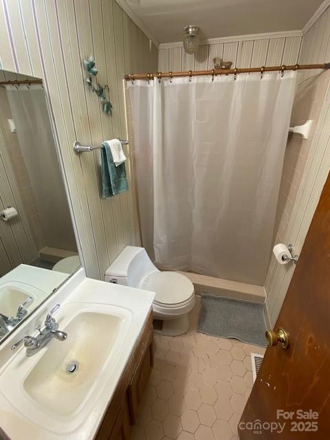 13427 Homewood Dr, Charlotte, NC 28262 - bathroom featuring toilet, tile patterned floors, vanity, a shower with shower curtain, and wood walls