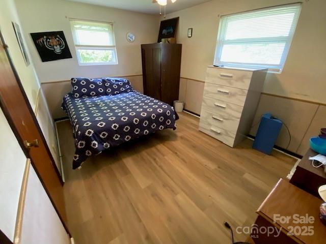 13427 Homewood Dr, Charlotte, NC 28262 - bedroom featuring light wood finished floors and multiple windows