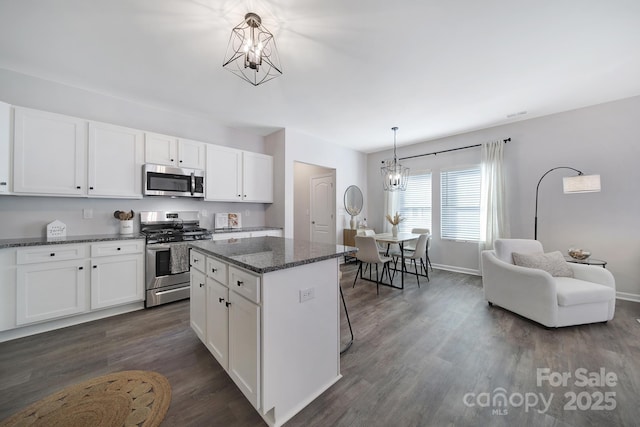 240 Briana Marie Way, Indian Trail, NC 28079 - kitchen featuring stainless steel appliances, a chandelier, dark wood-style flooring, a kitchen island, and white cabinetry