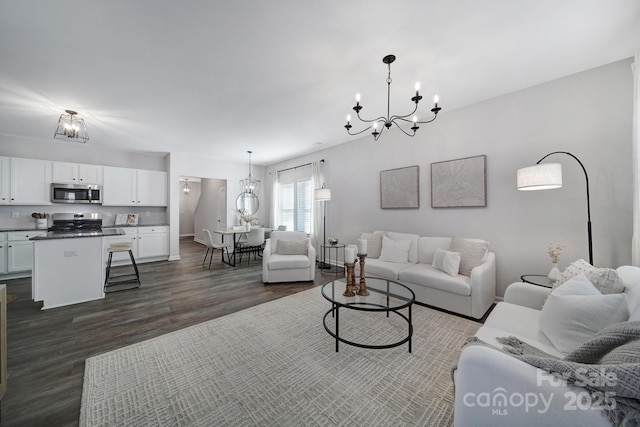 240 Briana Marie Way, Indian Trail, NC 28079 - living room featuring a chandelier, dark wood-type flooring, and baseboards
