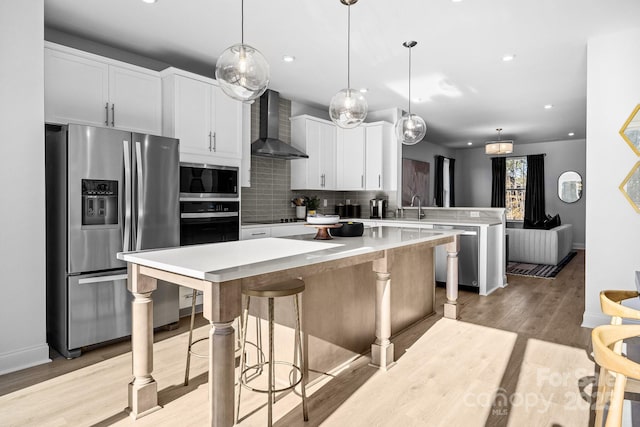 3236 Drift St Unit 58End, Charlotte, NC 28278 - kitchen with stainless steel appliances, wall chimney exhaust hood, a peninsula, a kitchen island, and tasteful backsplash