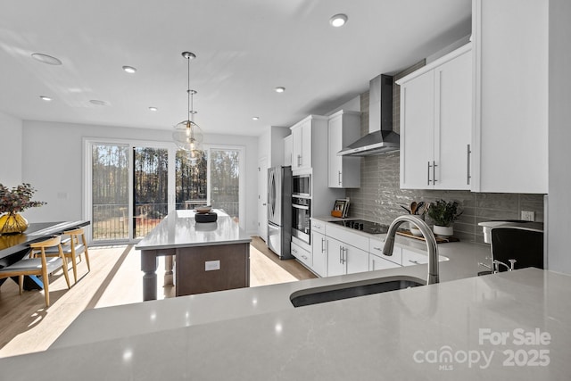 3236 Drift St Unit 58End, Charlotte, NC 28278 - kitchen featuring wall chimney exhaust hood, stainless steel appliances, a sink, a kitchen island, and decorative backsplash