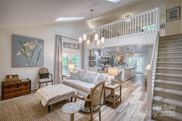 206 Independence Trl, Morganton, NC 28655 - living area with a skylight, light wood-type flooring, stairs, lofted ceiling, and a chandelier