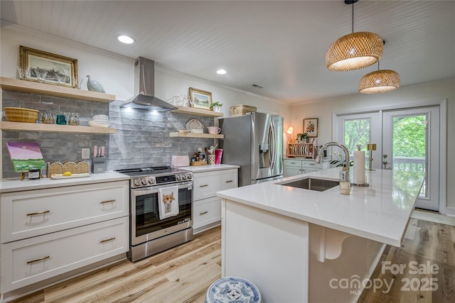 206 Independence Trl, Morganton, NC 28655 - kitchen with stainless steel appliances, wall chimney range hood, a sink, open shelves, and light wood-style flooring
