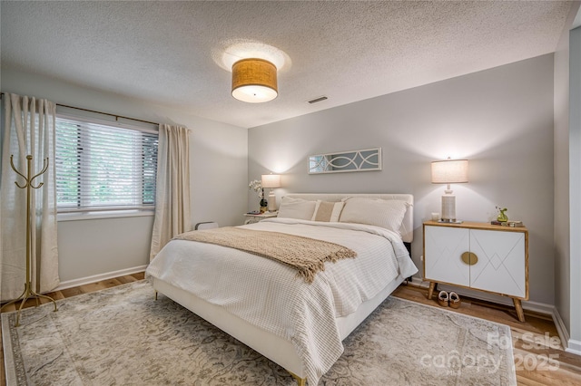 206 Independence Trl, Morganton, NC 28655 - bedroom with wood finished floors, baseboards, and a textured ceiling