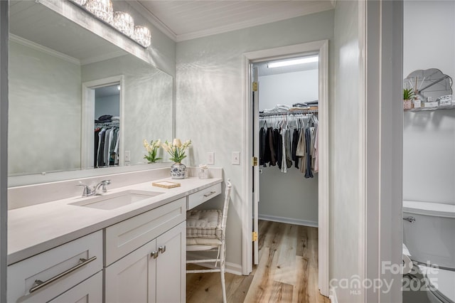 206 Independence Trl, Morganton, NC 28655 - bathroom with vanity, wood finished floors, a spacious closet, toilet, and crown molding