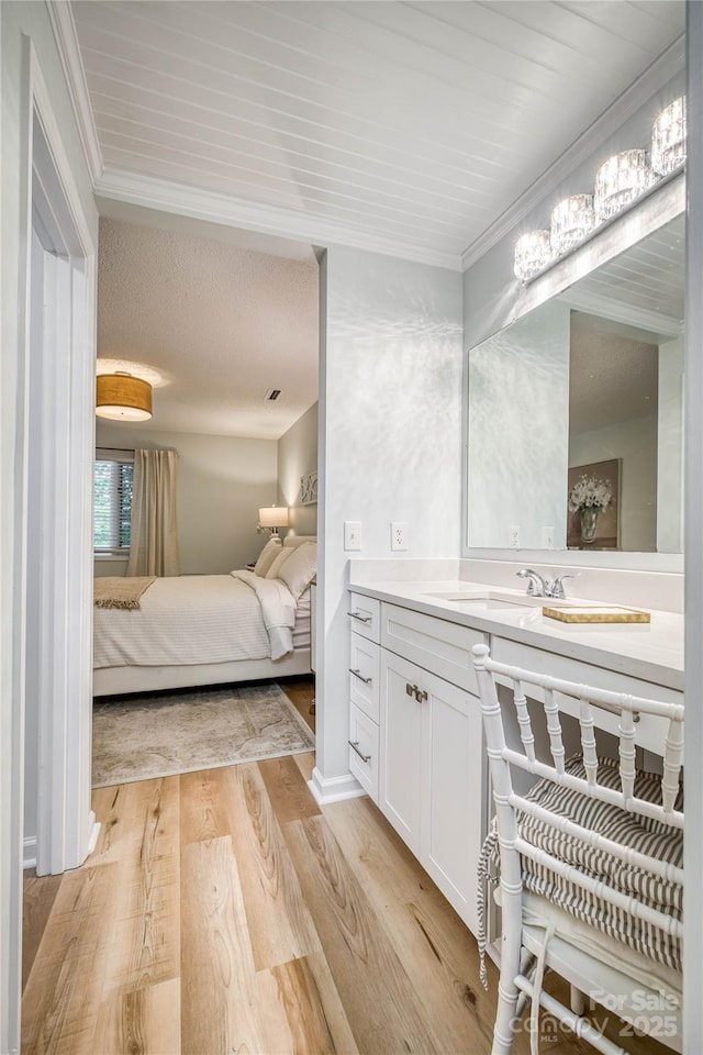 206 Independence Trl, Morganton, NC 28655 - ensuite bathroom with vanity, wood finished floors, and crown molding