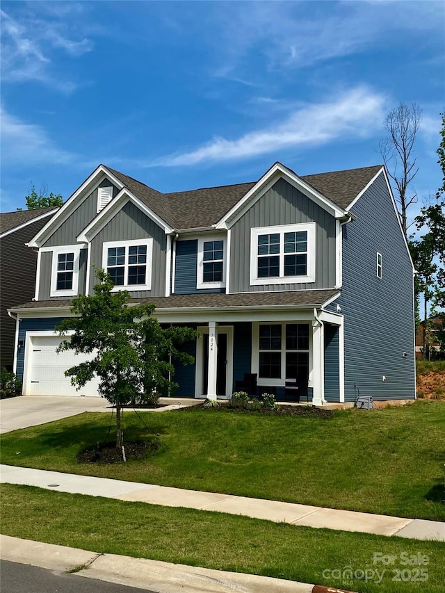 7024 Wheyfield Dr, Charlotte, NC 28215 - view of front of property featuring a garage, driveway, board and batten siding, and covered porch