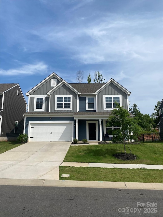 7024 Wheyfield Dr, Charlotte, NC 28215 - view of front of property with board and batten siding, an attached garage, and driveway