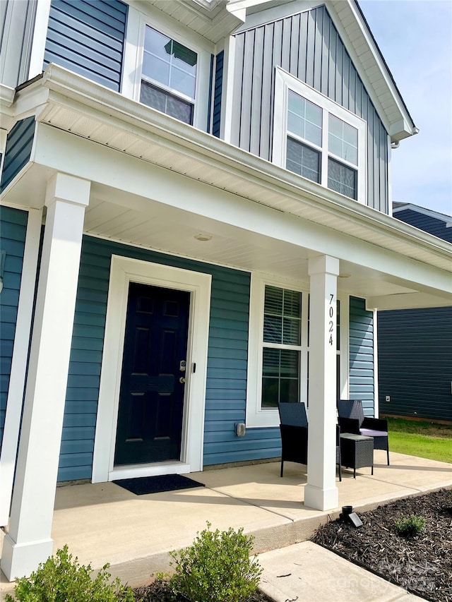 7024 Wheyfield Dr, Charlotte, NC 28215 - property entrance featuring a porch and board and batten siding