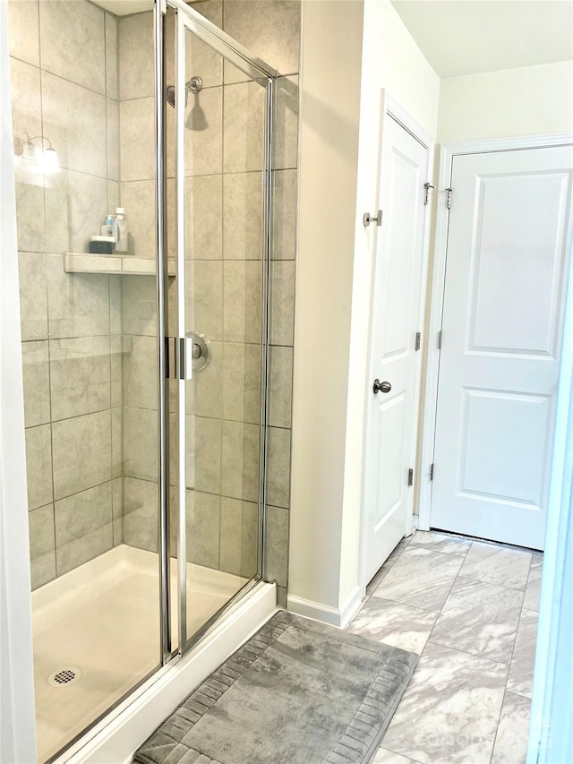 7024 Wheyfield Dr, Charlotte, NC 28215 - bathroom with a shower stall, baseboards, and marble finish flooring