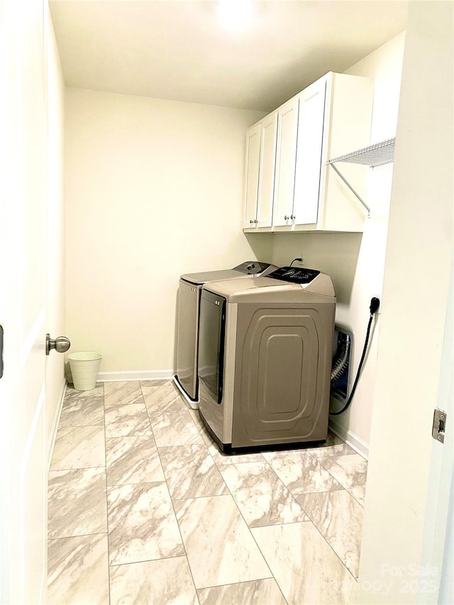 7024 Wheyfield Dr, Charlotte, NC 28215 - laundry room featuring cabinet space, washing machine and clothes dryer, light marble finish floors, and baseboards