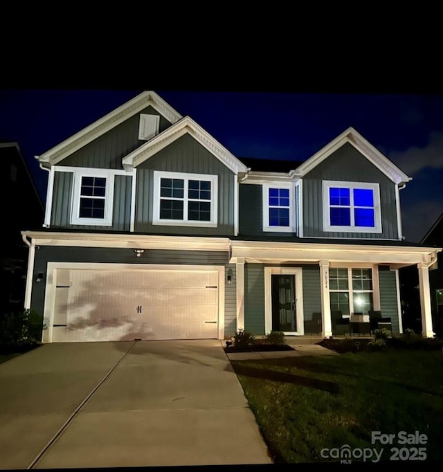 7024 Wheyfield Dr, Charlotte, NC 28215 - view of front of home featuring an attached garage, concrete driveway, board and batten siding, and covered porch