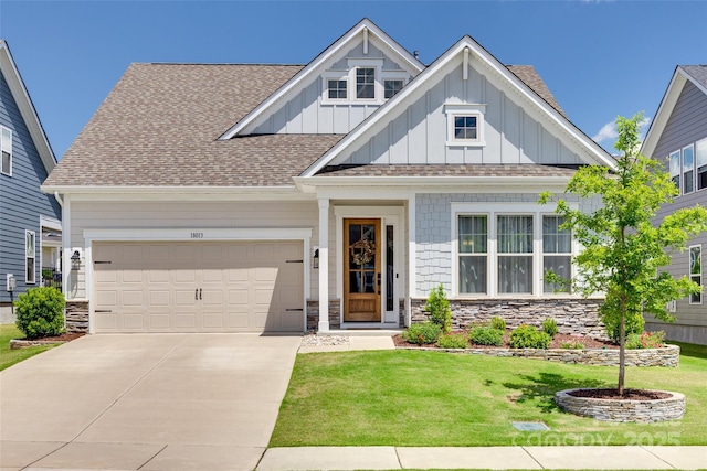 18013 Grey Mossrun Dr, Charlotte, NC 28278 - craftsman house with board and batten siding, a garage, concrete driveway, a front lawn, and stone siding