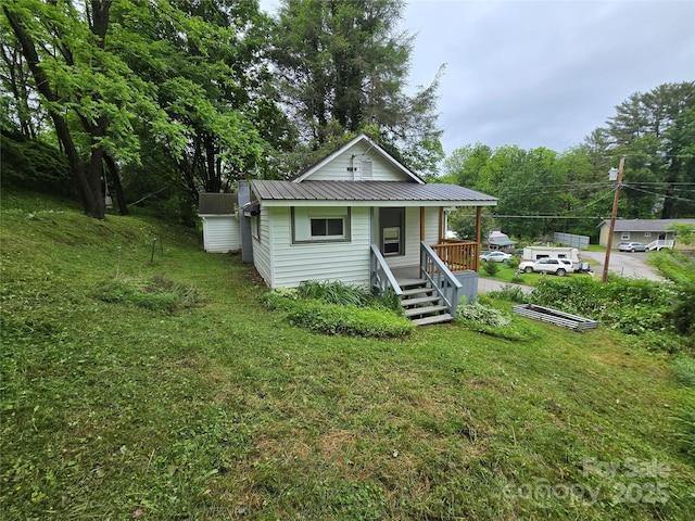 151 S Hill St, Waynesville, NC 28786 - view of front of home with a porch, metal roof, and a front lawn