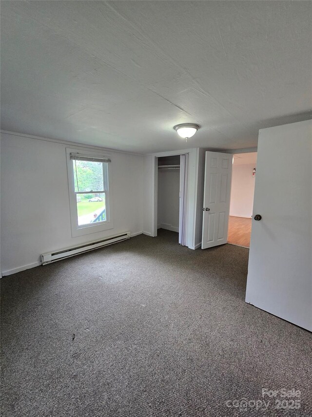 151 S Hill St, Waynesville, NC 28786 - unfurnished bedroom featuring a baseboard radiator, carpet, and a closet