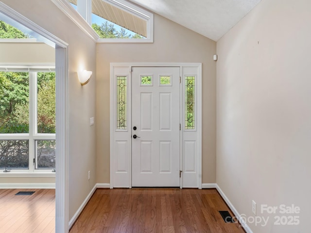 18 Westbridge Dr, Hendersonville, NC 28739 - foyer entrance with vaulted ceiling, wood finished floors, and baseboards