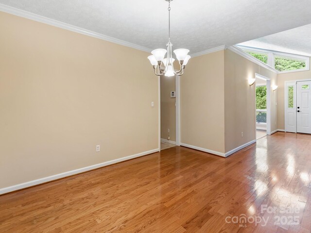 18 Westbridge Dr, Hendersonville, NC 28739 - spare room with baseboards, a chandelier, ornamental molding, and light wood-type flooring