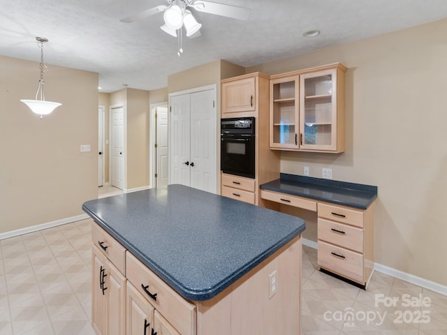18 Westbridge Dr, Hendersonville, NC 28739 - kitchen featuring light brown cabinetry, black oven, dark countertops, a ceiling fan, and glass insert cabinets