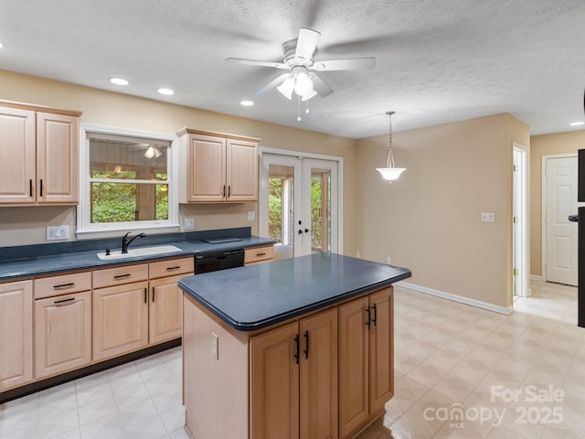 18 Westbridge Dr, Hendersonville, NC 28739 - kitchen featuring a sink, black dishwasher, light brown cabinetry, dark countertops, and plenty of natural light