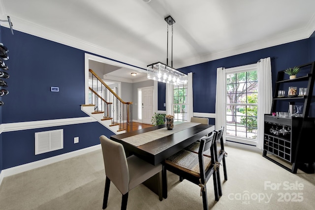16714 Hammock Creek Pl, Charlotte, NC 28278 - dining space featuring light carpet, crown molding, stairs, and a chandelier