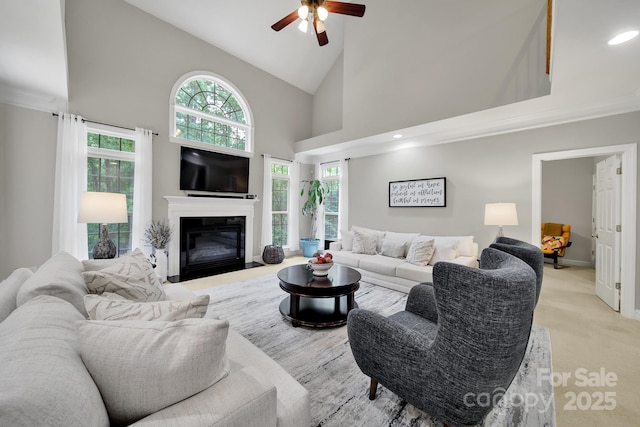 16714 Hammock Creek Pl, Charlotte, NC 28278 - living area with ceiling fan, a glass covered fireplace, high vaulted ceiling, recessed lighting, and ornamental molding