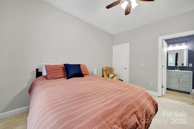 16714 Hammock Creek Pl, Charlotte, NC 28278 - bedroom featuring light colored carpet, baseboards, a sink, connected bathroom, and a ceiling fan
