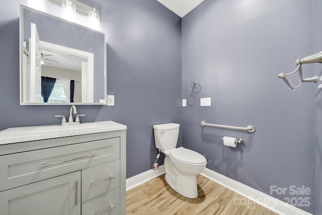 16714 Hammock Creek Pl, Charlotte, NC 28278 - half bathroom featuring wood finished floors, baseboards, toilet, vanity, and a ceiling fan