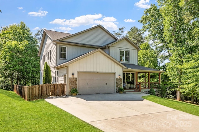 51 Cherry Ridge Ln, Weaverville, NC 28787 - view of front of home featuring covered porch, concrete driveway, an attached garage, and stone siding