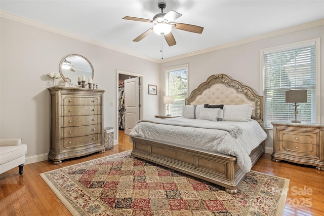 51 Cherry Ridge Ln, Weaverville, NC 28787 - bedroom with a spacious closet, light wood-type flooring, crown molding, baseboards, and a ceiling fan