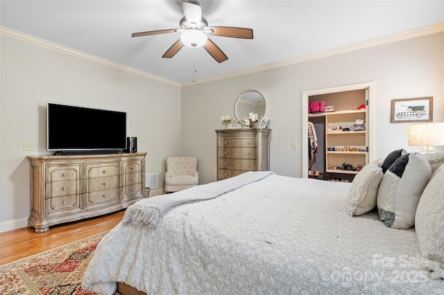 51 Cherry Ridge Ln, Weaverville, NC 28787 - bedroom featuring wood finished floors, crown molding, a walk in closet, ceiling fan, and a closet