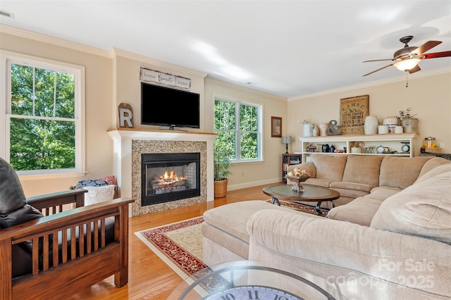 51 Cherry Ridge Ln, Weaverville, NC 28787 - living area with wood finished floors, crown molding, a glass covered fireplace, ceiling fan, and baseboards